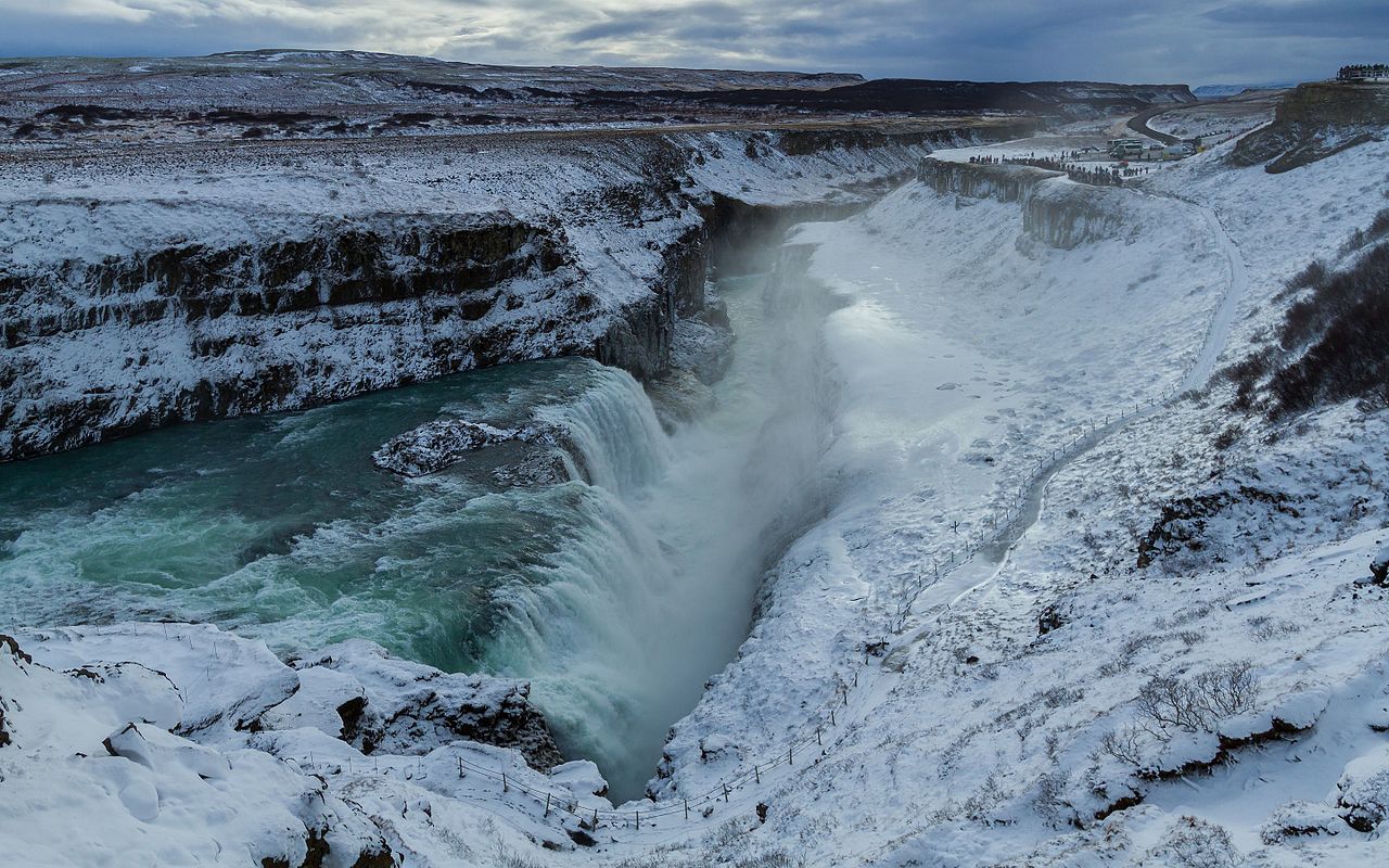 Seljalandsfoss waterfall with person walking behind the cascade
