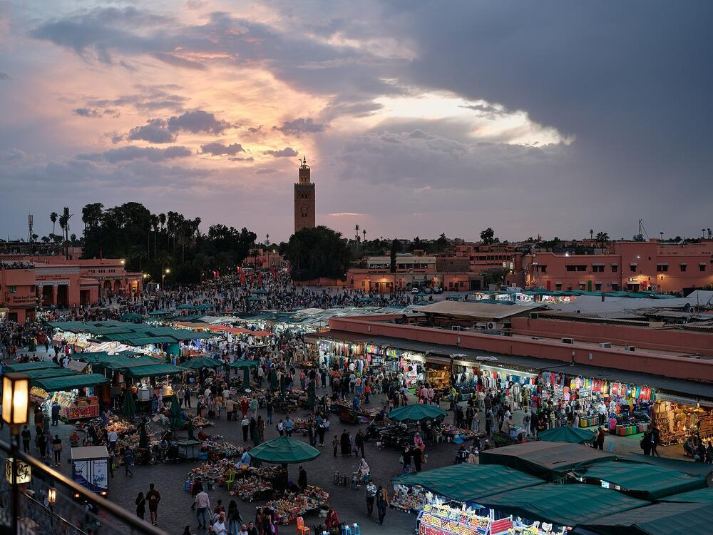 Jemaa el-Fnaa at sunset with the Koutoubia minaret behind