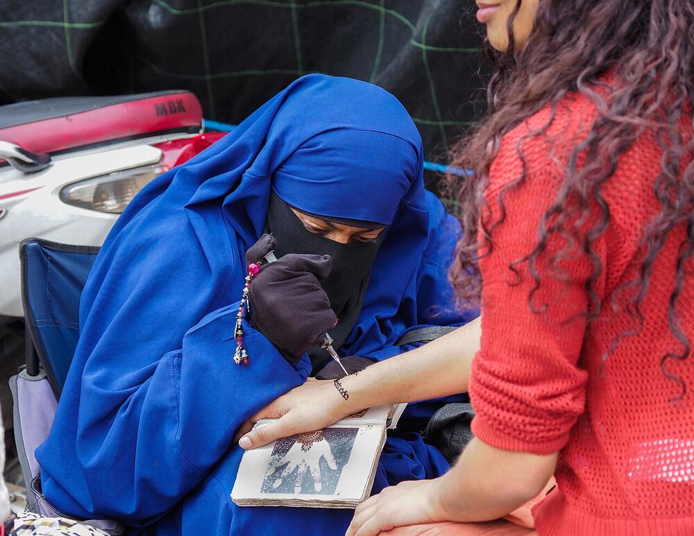 A henna artist at work in Jemaa el-Fnaa, March 2024