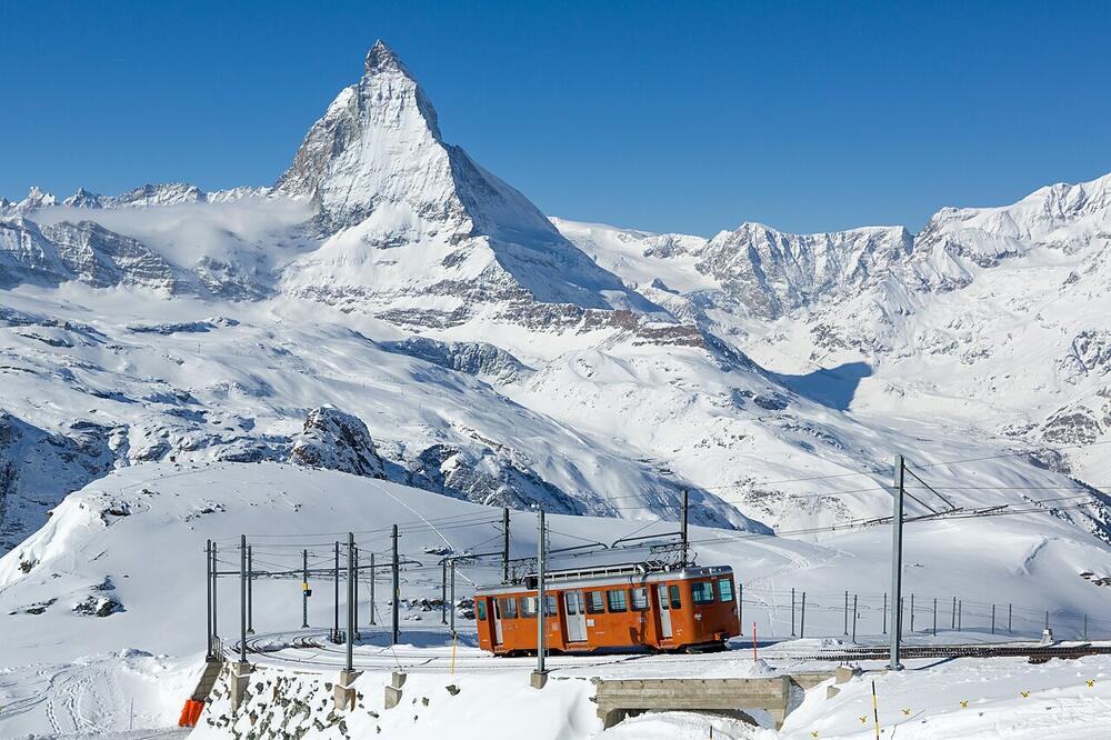 A Gornergrat railway car below the summit station, with the snow-covered Matterhorn behind, February